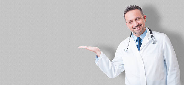 istock Young medical doctor smiling and presenting something with his h 537269758