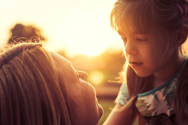 istock Mother and daughter looking at each other at sunset 537271306