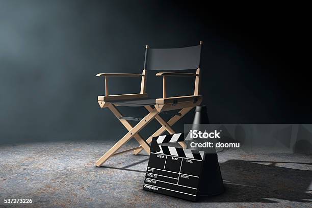 Director Chair Movie Clapper And Megaphone In The Volumetric Li Stock Photo - Download Image Now