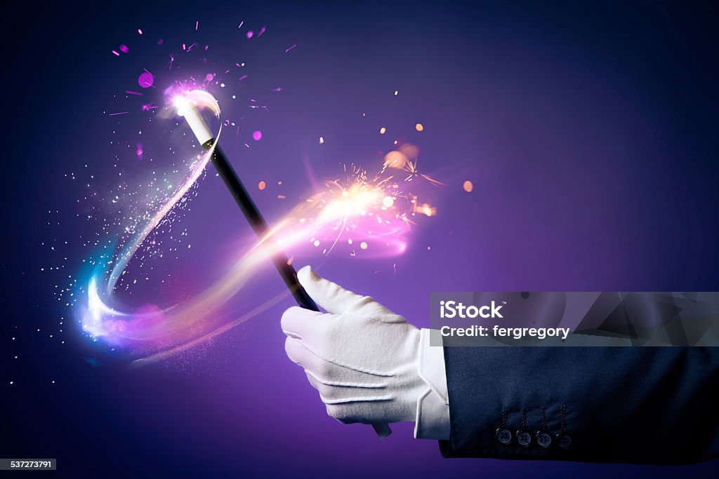 High contrast image of magician hand with magic wand Magician hand with magic wand Magic Wand Stock Photo