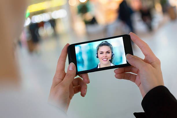 woman hand holding a smartphone during a skype video stock photo