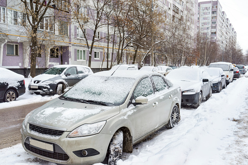 Snow covered cars in the street