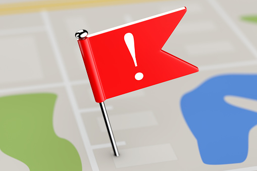 Red Flag with Exclamation Mark on Map Background extreme closeup. 3d Rendering