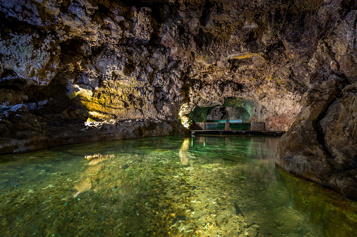 Underground lake inside the natural volcanic caves. Sao Vicence, Madeira island, Portugal.