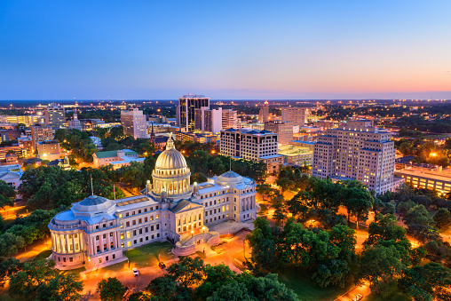 City skyline view over the downtown buildings and statehouse of Indianapolis, Indiana, USA at sunrise