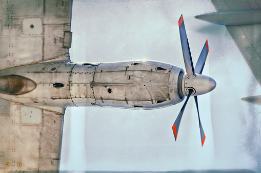 Detail of propeller-driven aircraft with wing. Retro manipulated picture.