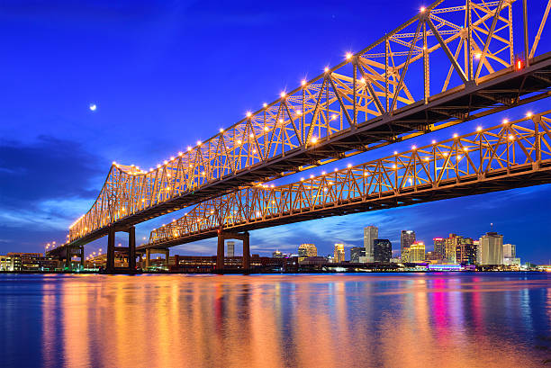 New Orleans Skyline New Orleans, Louisiana, USA at Crescent City Connection Bridge over the Mississippi River. mississippi river stock pictures, royalty-free photos & images