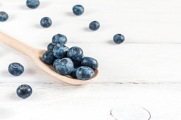 istock blueberries on wooden spoon close-up 537284216