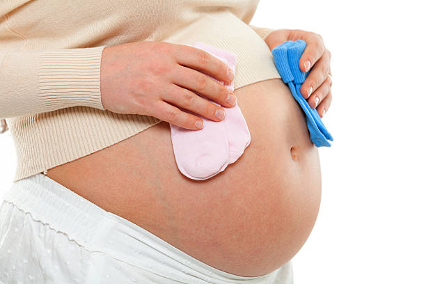 istock Pregnant woman with child socks 537284860