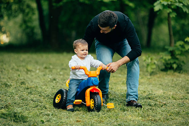istock Son ride on a bicycle with help of father 537287026