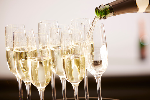 Champagne drinks being poured on a tray