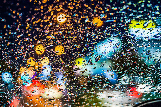 istock drops of rain on window with bokeh lights 537289116