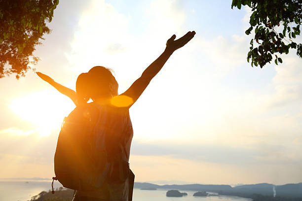 istock cheering hiking woman sunset seaside 537289193