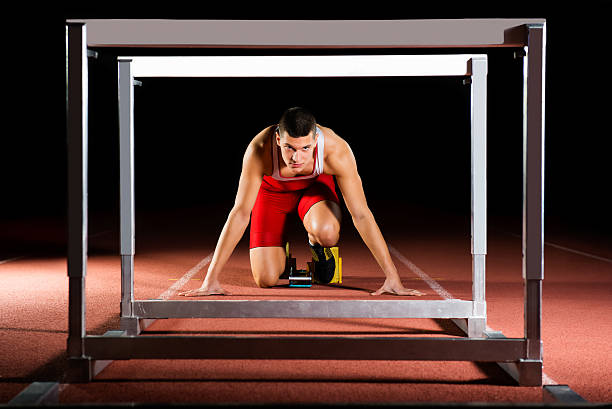 istock Athlete on the starting blocks with hurdles 537289251