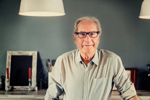 istock Confident senior man smiling at home 537291548