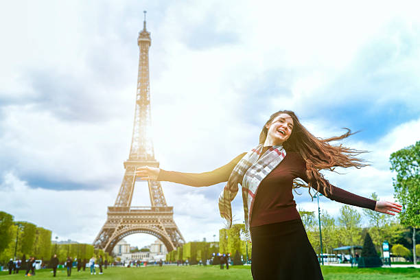 istock Pretty young woman arm raised for freedom at Eiffel tower 537292016