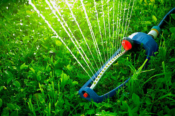 istock Lawn sprinkler spaying water over green grass. 537292886