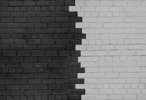 brick wall parted on dark and light sides - yin yang symbol fotos imagens e fotografias de stock