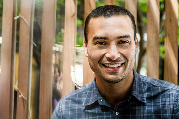 istock Businessman smiling against fence 537293562