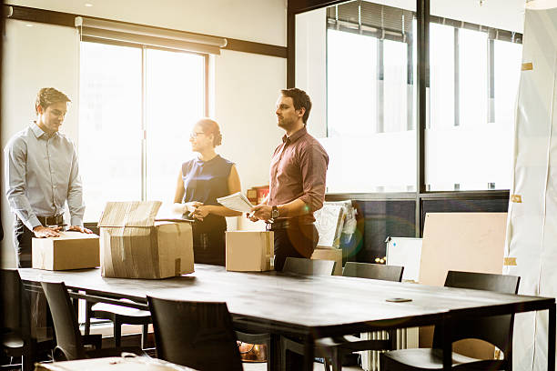 istock Business people with packing boxes in board room 537293806