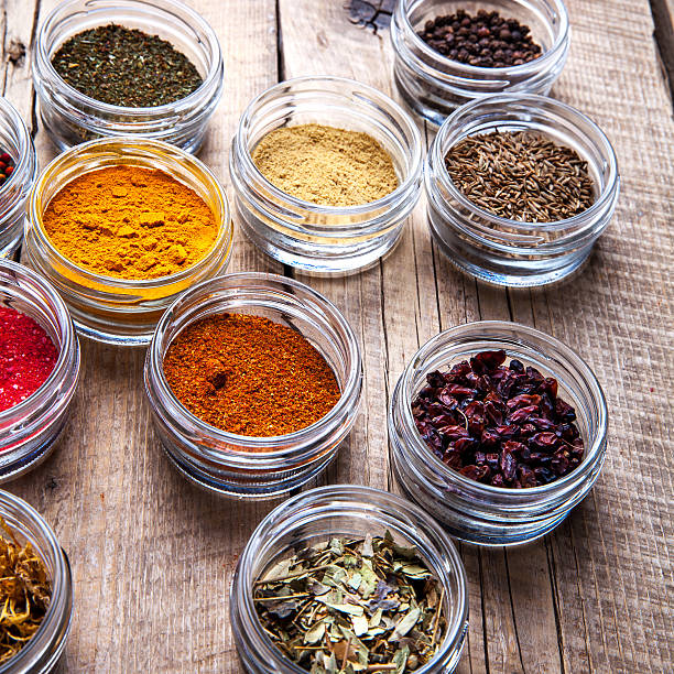 istock Spices in jars on wooden background. Food 537295900