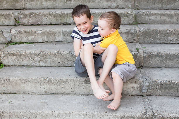 istock cheerful brothers playfully fighting and tickle each other 537302400