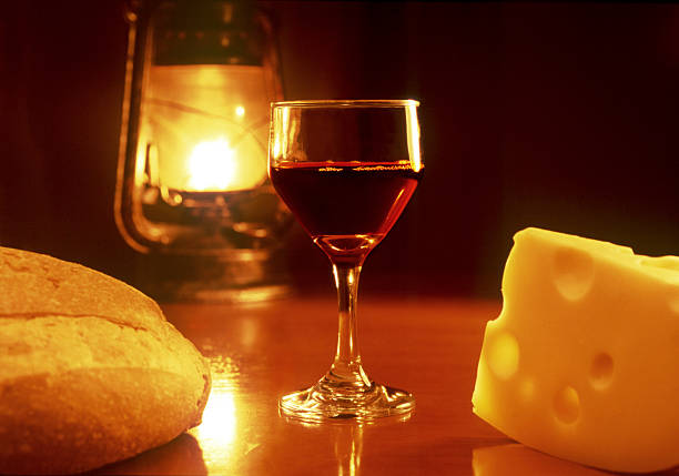 Glass of wine with cheese and bread.