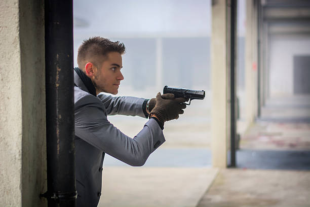 istock Well dressed handsome young detective, policeman or mobster holding a 537302741