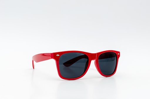 Red stylish sunglasses isolated on white background