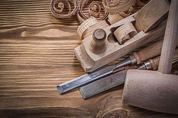 istock Flat chisels planer curled shavings lump hammer on wood board 537305524
