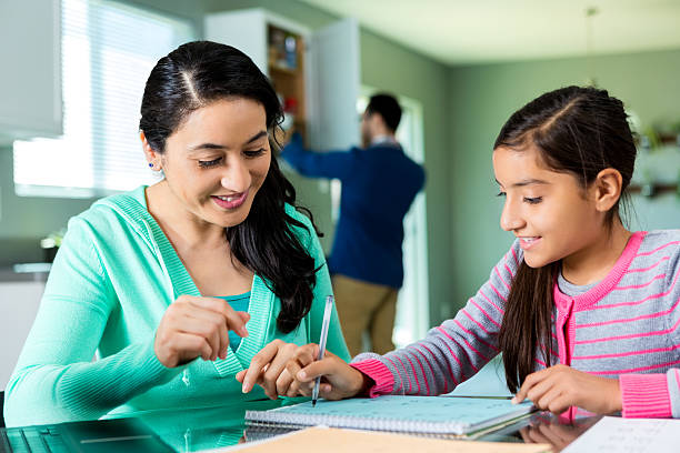 istock Happy mom helps her daughter with homework 537305540