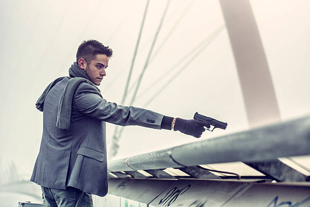 istock Young detective, policeman or mobster firing a gun 537305751