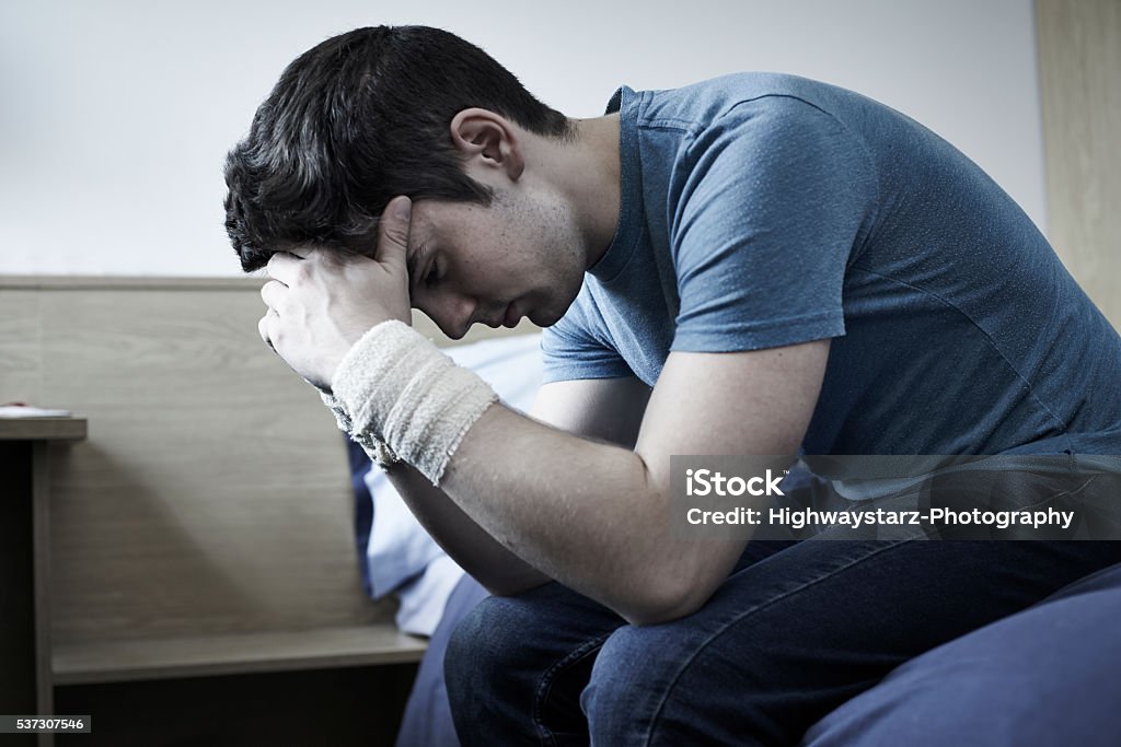 Depressed Young Man With Bandaged Wrists After Suicide Attempt Self Harm Stock Photo
