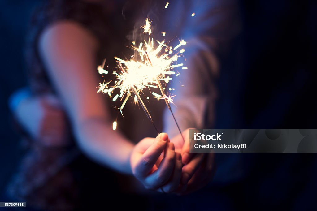 sparklers in the hands of the couple sparklers in the hands of a loving couple Firework Display Stock Photo