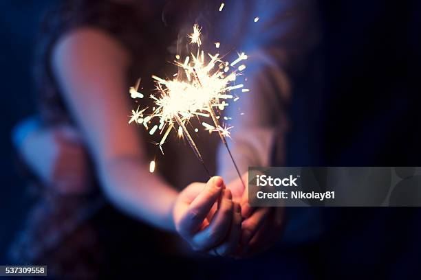 Sparklers In The Hands Of The Couple Stock Photo - Download Image Now - Firework Display, Firework - Explosive Material, Sparkler - Firework