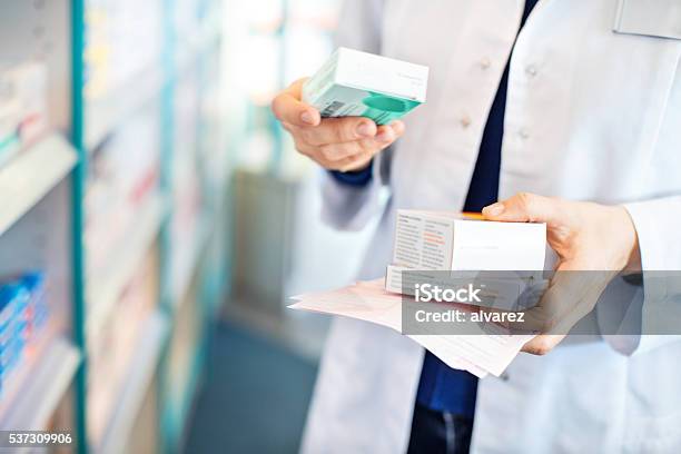 Pharmacists Hands Taking Medicines From Shelf Stock Photo - Download Image Now - Pharmacy, Medicine, Pharmacist