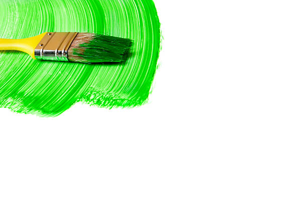 istock Paintbrush with green paint (isolated on white) 537311190