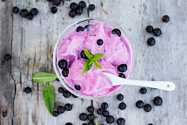 blackcurrant ice cream blackcurrant ice cream  on the old table frozen yoghurt stock pictures, royalty-free photos & images