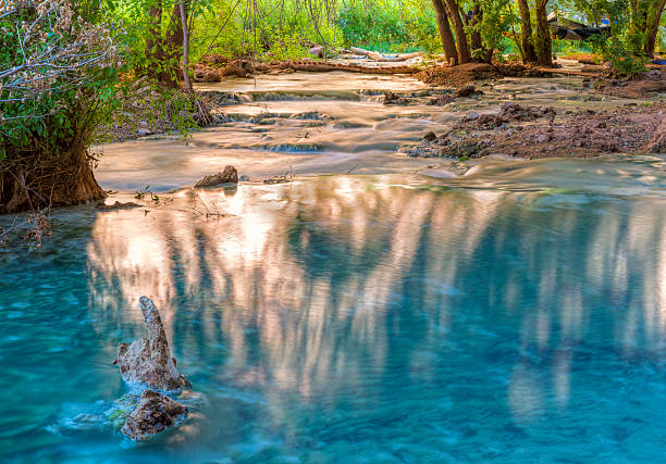 Havasu Creek Reflected Light Sunlight bounces off the far cliffs and lights up reflections in Havasu Creek on the Havasupai Indian Reservation in the Grand Canyon. harasu canyon stock pictures, royalty-free photos & images