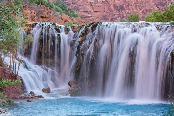 Little Navajo Falls on Havasu Creek Silly water flows over Little Navajo Falls into a turquoise pool on the Havasupai Indian Reservation in the Grand Canyon. harasu canyon stock pictures, royalty-free photos & images