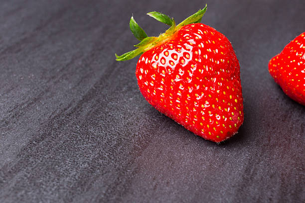istock tasty strawberries isolated on black background, stone tile 537313744