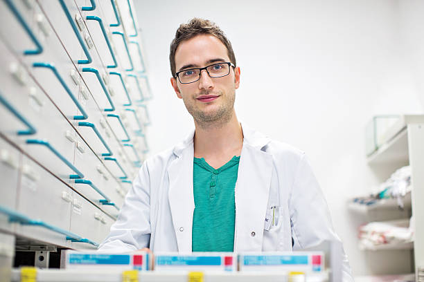 istock Confident male pharmacist standing at medicine shelf 537313818