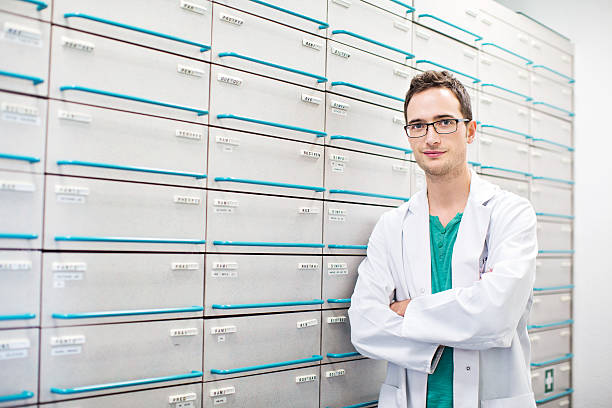 istock Confident pharmacist standing by a medicine shelf 537314392