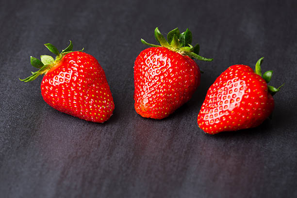 istock tasty strawberries isolated on black background, stone tile 537314468