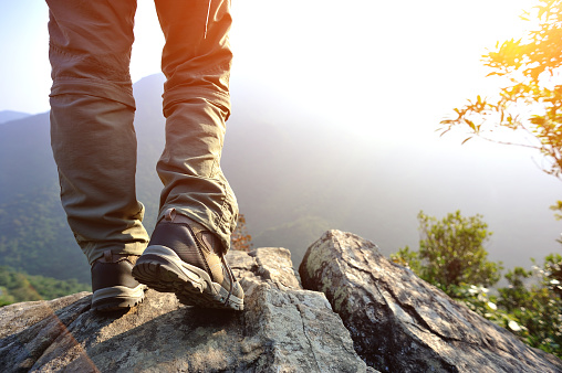 hiking feet  mountain peak rock enjoy the view