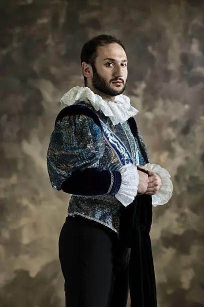 Portrait of young man in theatrical costume. Looking at camera.