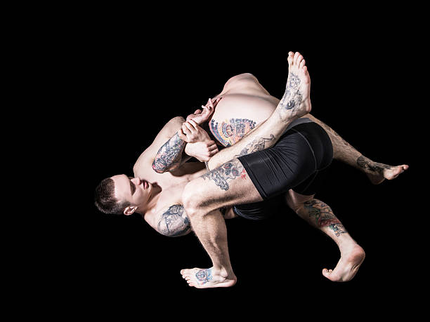 istock Strong MMA fighter holding his rival down and throwing punches 537315360