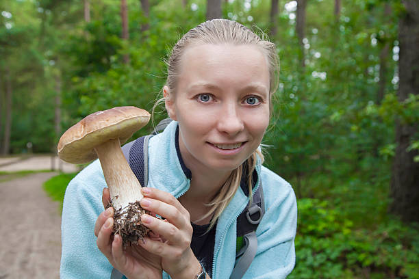 istock Woman with mashroom in the forest 537315581