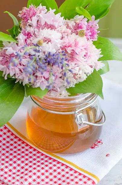 Honey can with daisy flower