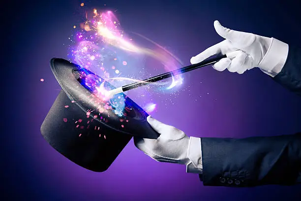 Magician hand with magic wand and hat